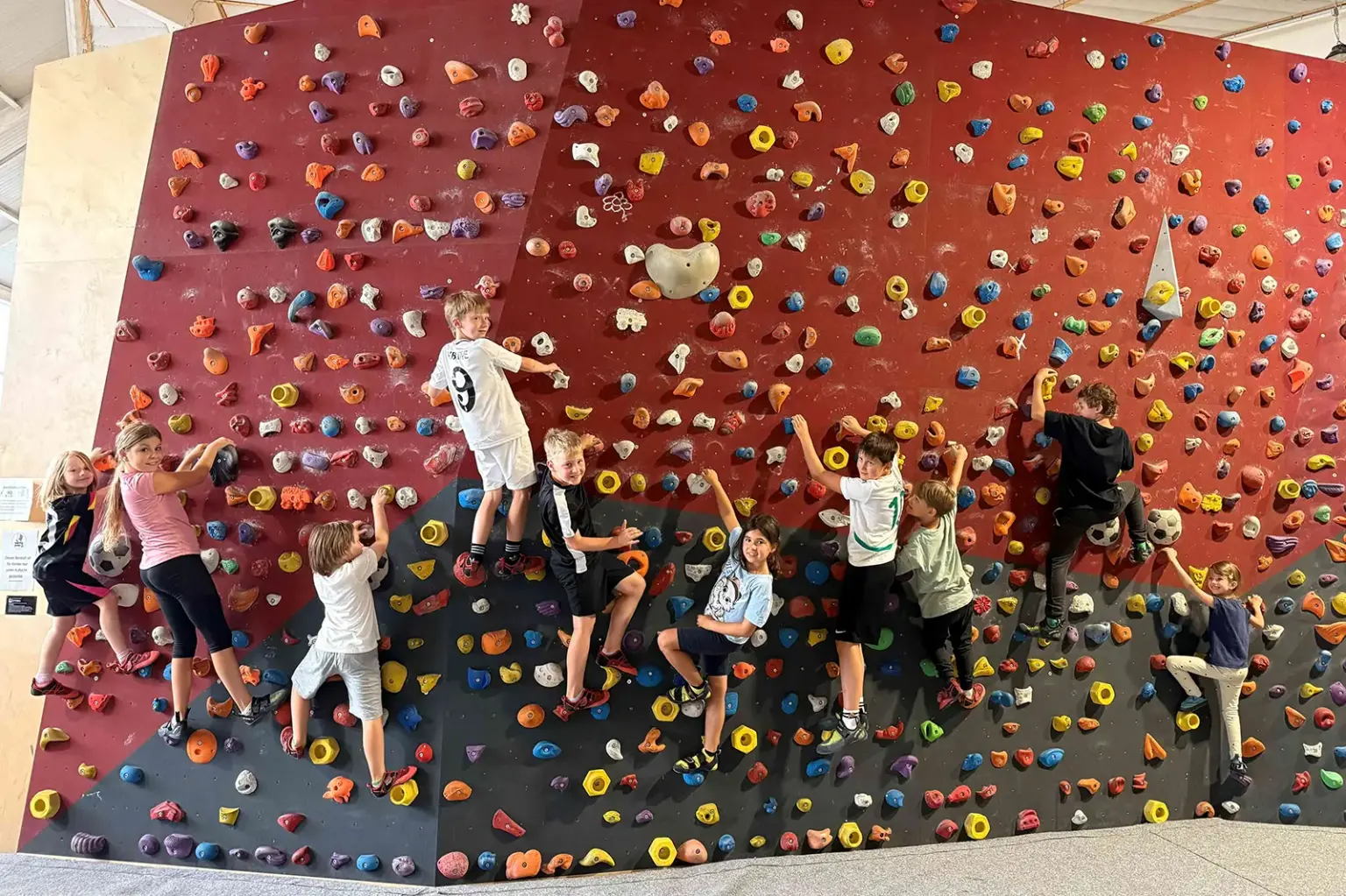 Eine Gruppe von Kindern an einer Kletterwand