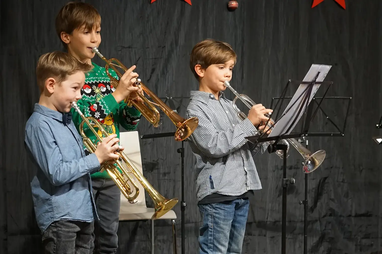 Drei Buben spielen Trompete