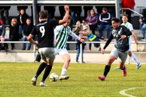 Ein Spieler von Breitenau kämpft sich durch zwei Gegner.