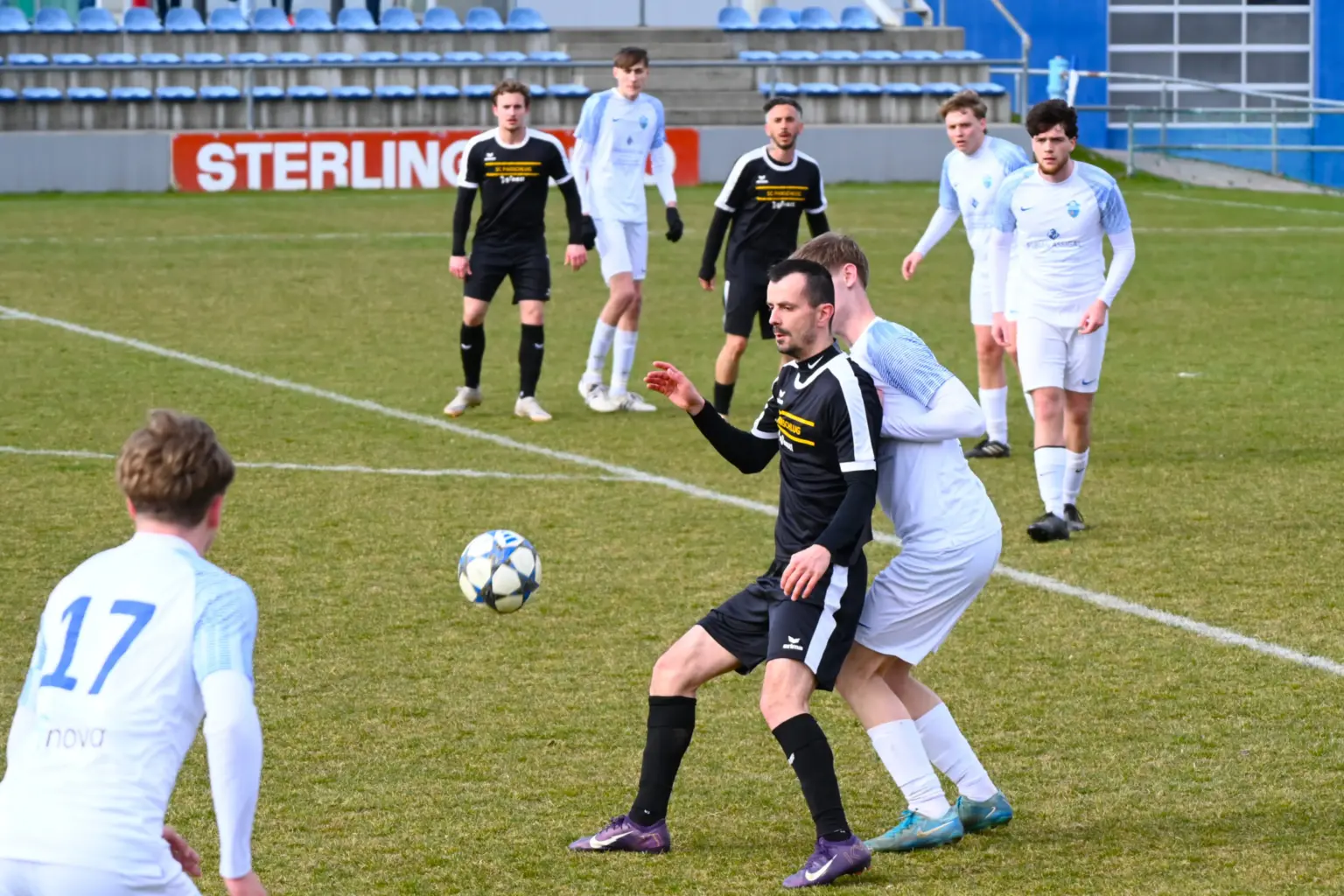 Ein hoher Ball hüpft auf zwei Spieler zu.