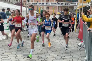 Jugendliche in Sportkleidung laufen durch eine Stadt