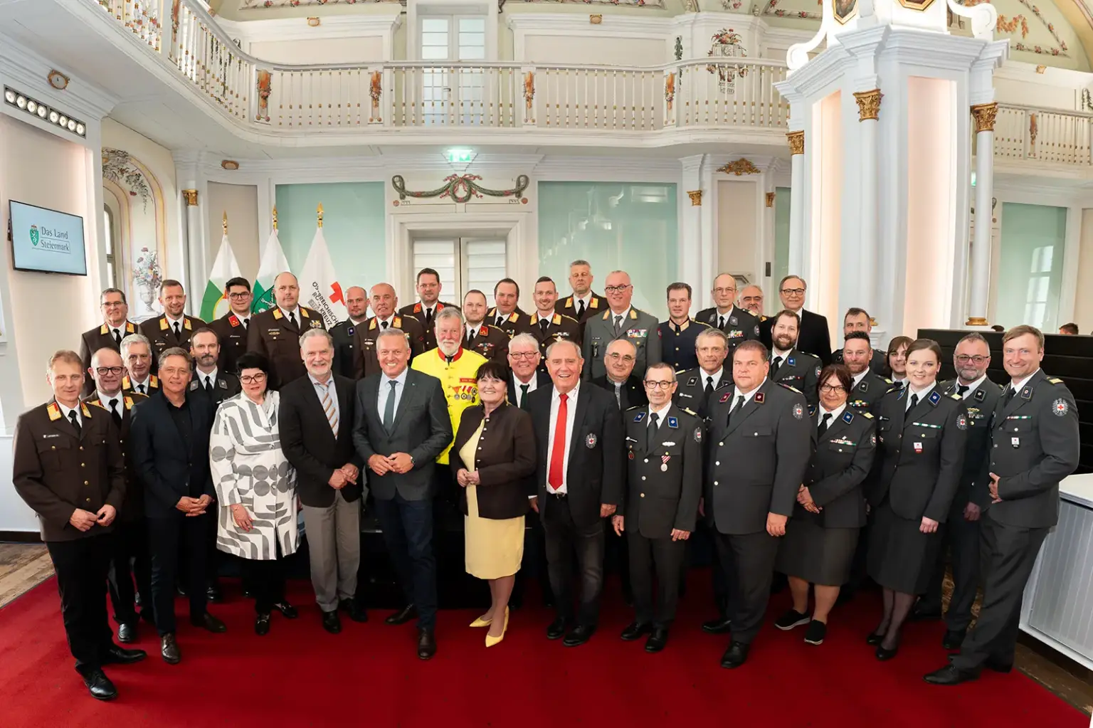 Eine große Gruppe von Personen in Uniform steht in einem großen Saal