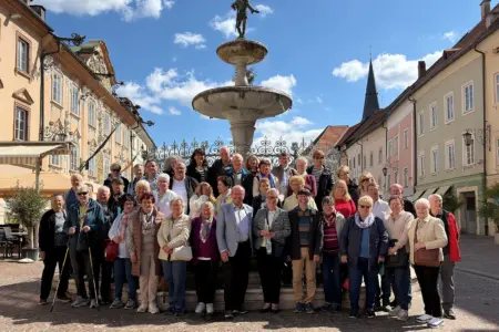 Eine Reisegruppe vor einem Denkmal.