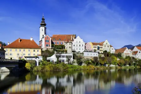Frohnleiten feiert Geburtstag Die Silhouette einer Stadt spiegelt sich in einem Fluss